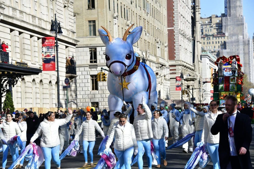 People dressed warmly, while walking in the Macy’s Thanksgiving Day Parade.