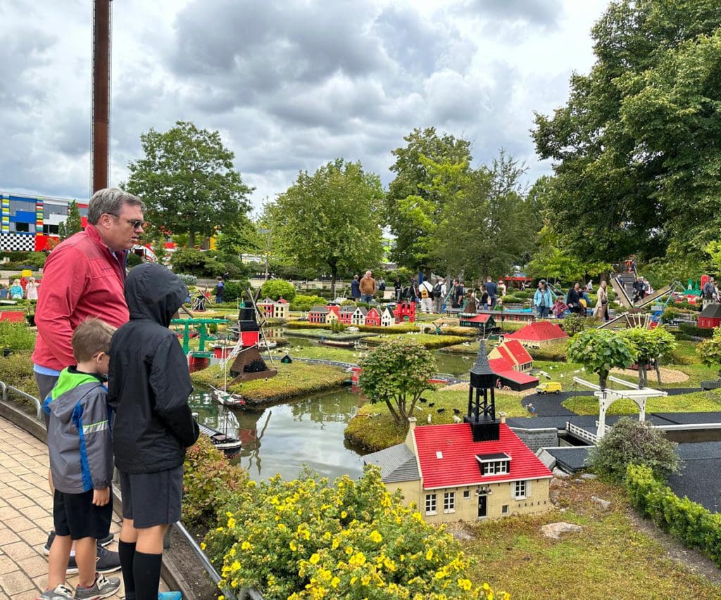 A dad and his young kids look at an outdoor lego production at LEGOLAND® Billund Resort.