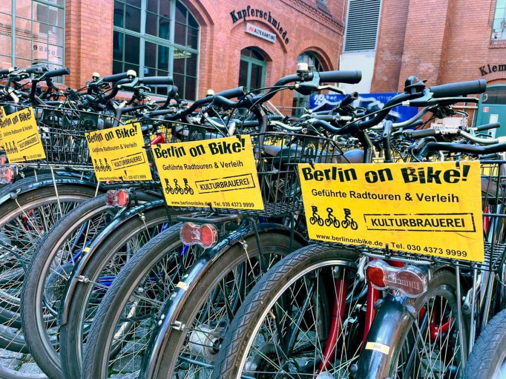 A line of bikes parked in Berlin awaiting a bike tour of the city, a must on any Berlin itinerary with kids.