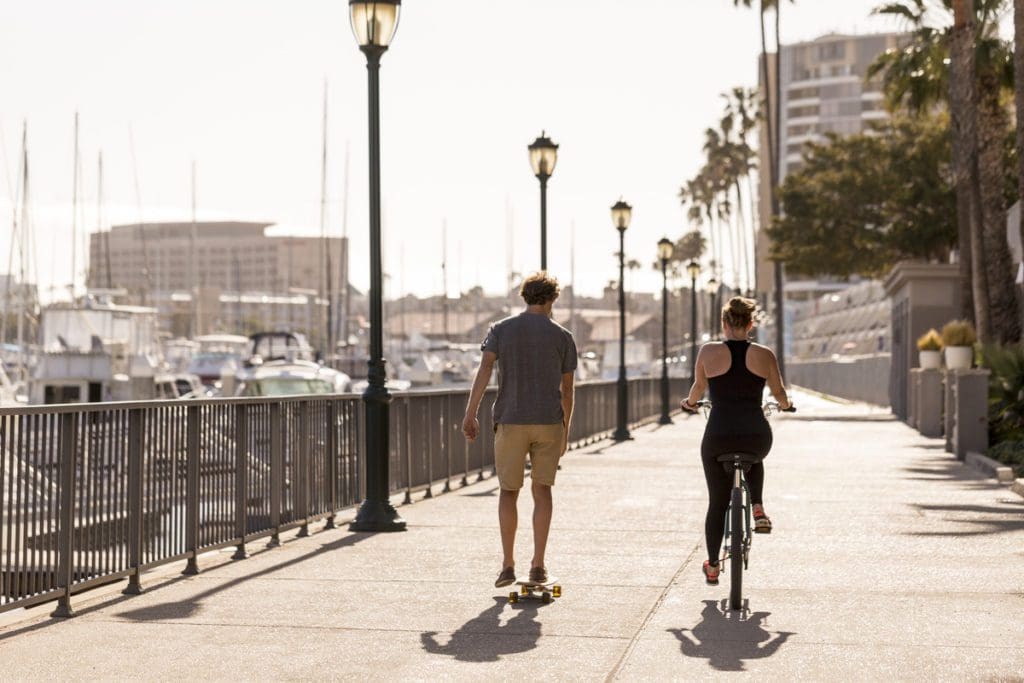 Two people walk along a boardwalk near The Ritz-Carlton, Marina del Rey.