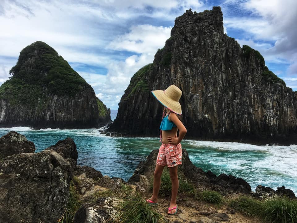 A young girl exploring the beautiful Fernando de Noronha in Brazil, one of the best places in South America with kids.