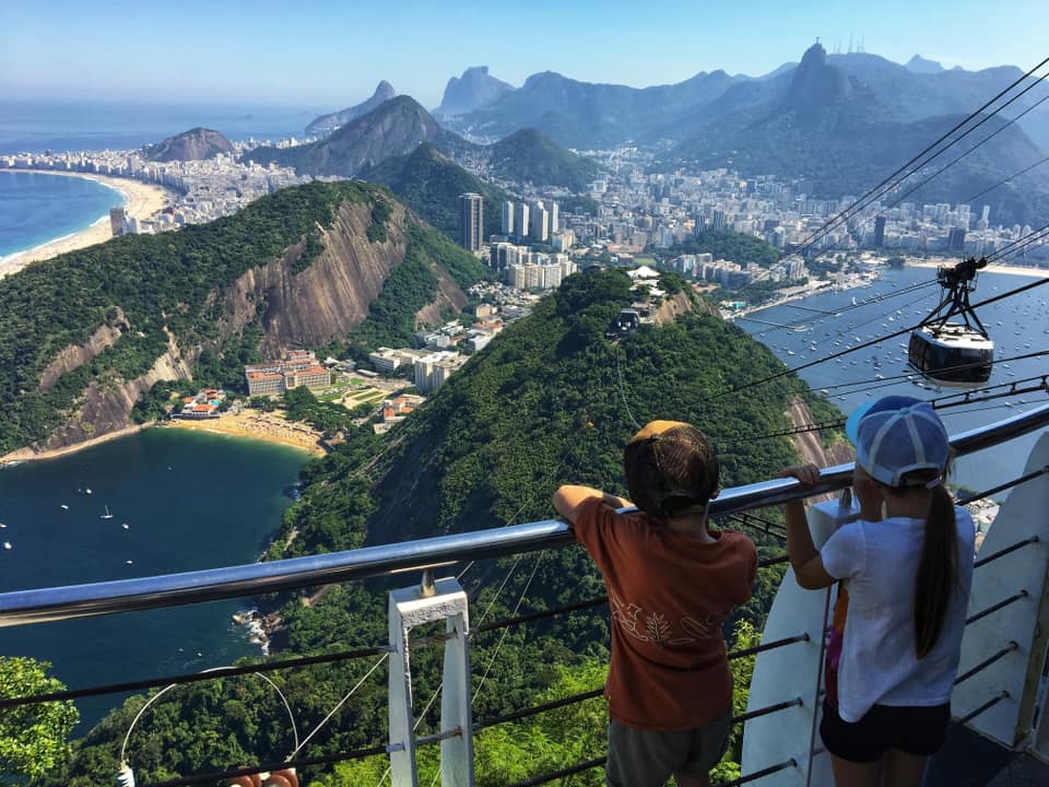 Two young kids enjoy a view of Rio de Janeiro in Brazil, one of the best destinations for New Year's with kids.