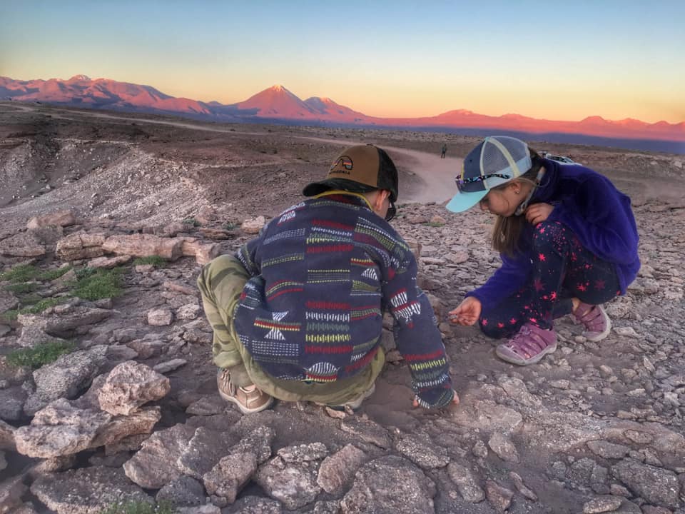 Two kids play together in the Atacama Desert.