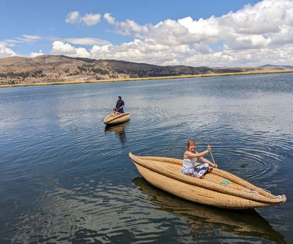 A family paddles along Lake Titicaca on woven boats.