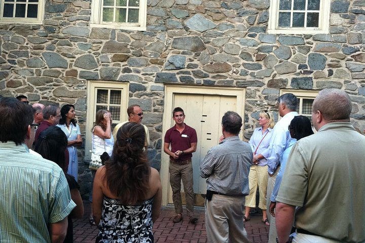 A tour guide leads a group on a Gastronomic Georgetown Food Tour.