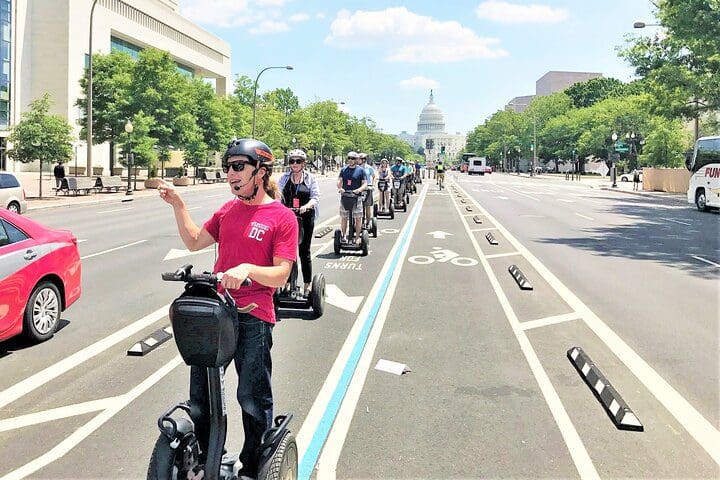 A tour guide leads a group of people on the Washington DC "See the City" Guided Sightseeing Segway Tour.