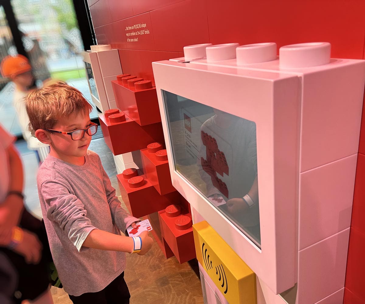 A young boy interacts with an exhibit at LEGOLAND® Billund Resort.
