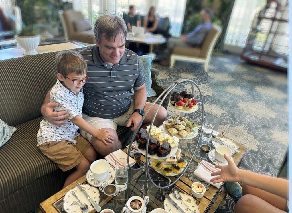 A dad and his young son enjoy High Tea at Nemacolin, a family resort in Pennsylvania your family will love.