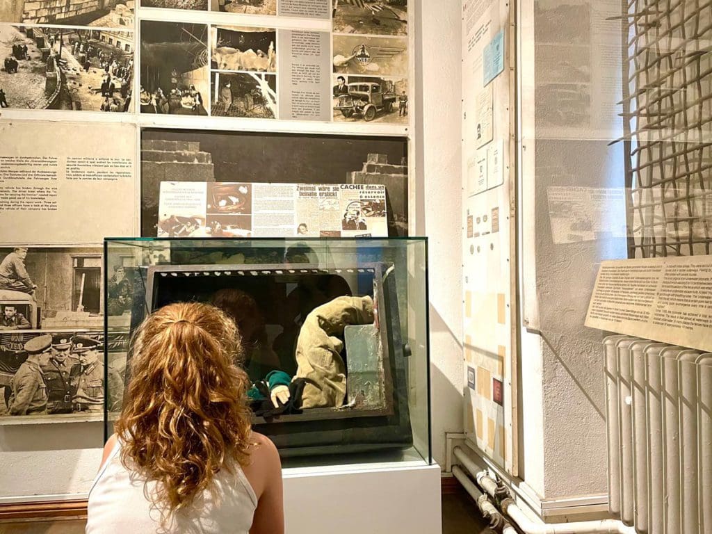 A young girl studies a display at the Charlie Mauer Museum, a great idea when planning a Berlin itinerary with kids.