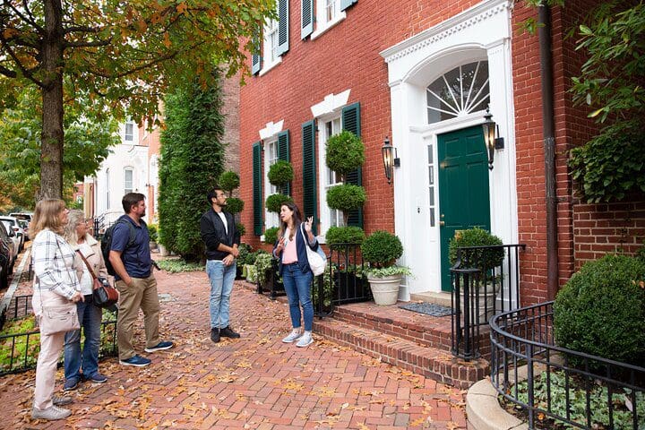 A tour guide shares a story while leading a Potomac River Cruise & Guided Georgetown Walking Tour.