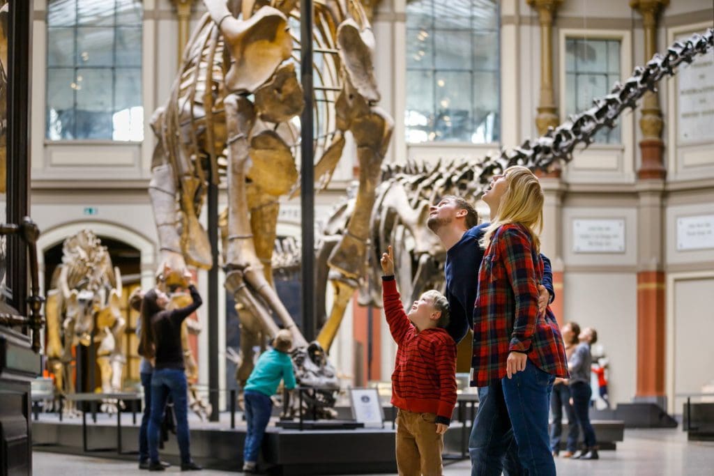 A family enjoys the dinosaur gallery at the Natural History Museum in Berlin.