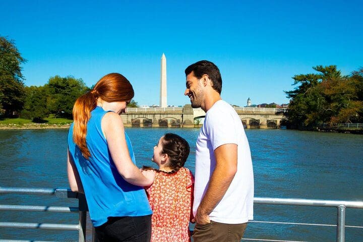 A family of three enjoys a view of the Washington Monument by cruise on the Washington DC Signature Scenic Lunch Cruise.