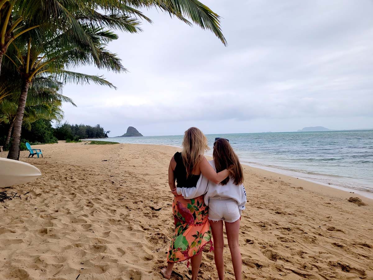 Mother and daughter stand together, enjoying the view at Kualoa Ranch's Secret Island.