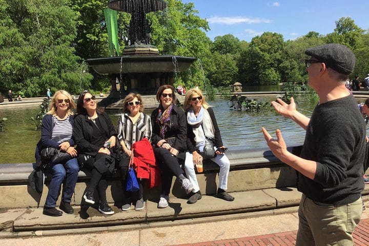 A tour group enjoys learning something new on the Central Park Walking Tour.