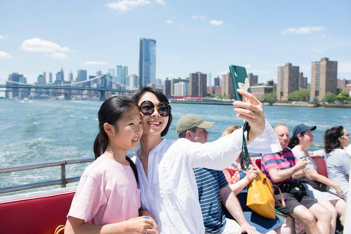 A mom and her young daughter take a selfie on the Circle Line: Complete Manhattan Island Cruise.
