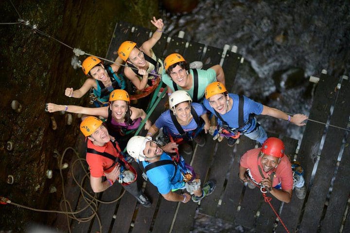 A group inside a cave, while on the Guachipelin Adventure Volcano Zipline Horseback River Tubing Combo.