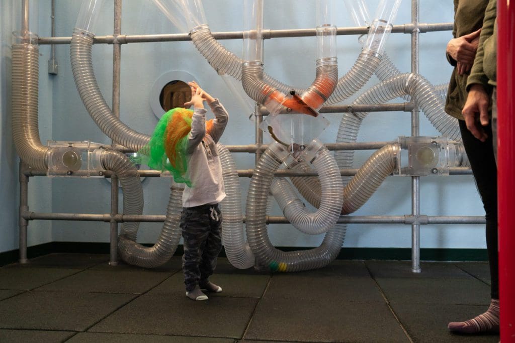 A young child plays at an exhibit in KidZone Museum.