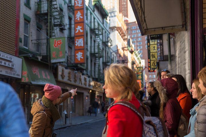 A tour group walks the NYC streets on the Soho, Little Italy, and Chinatown Walking Tour In New York.