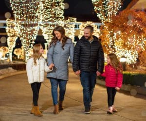 A family of four walks through holiday light displays in Coeur d'Alene.