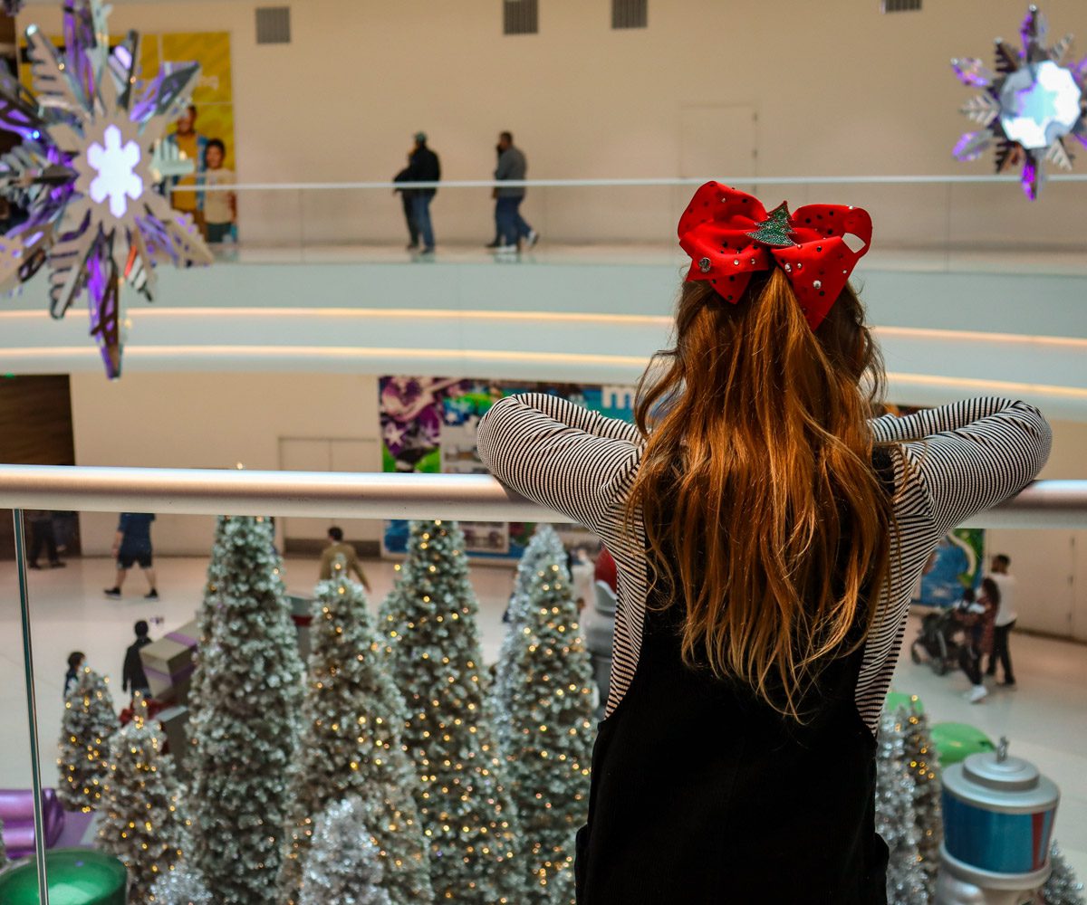 A young girl looks down on a holiday display at the Mall of America.