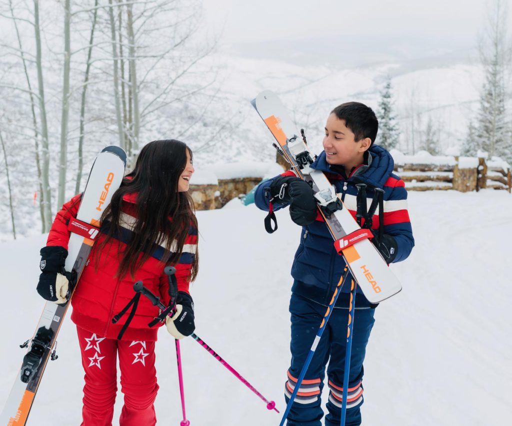 Two young kids holding skis in Beaver Creek, Colorado