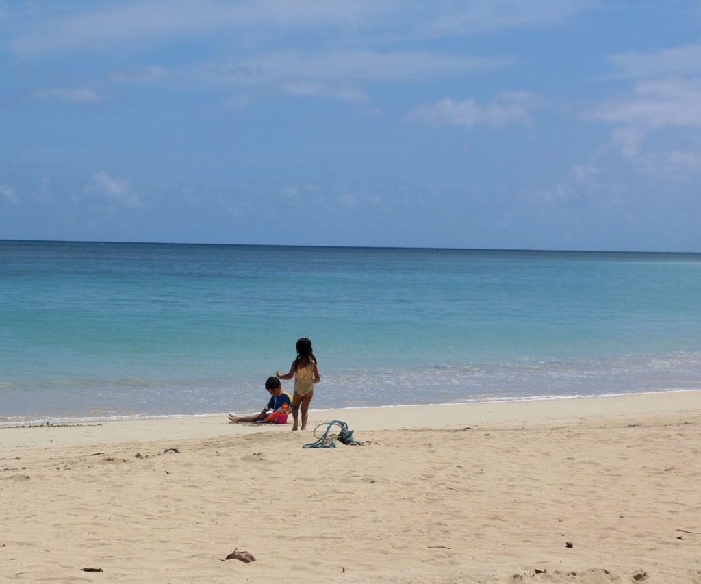 Two kids playing on the beach in the Dominican Republic.