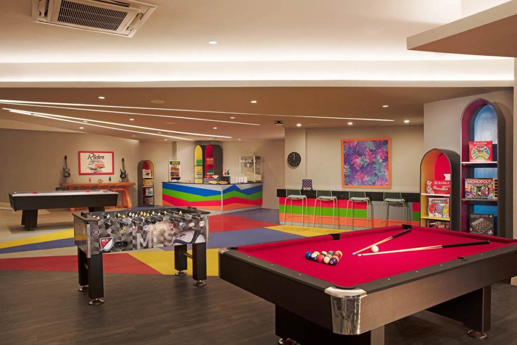 The Playroom at Dreams Dominicus La Romana with a pool table and more games for kids.