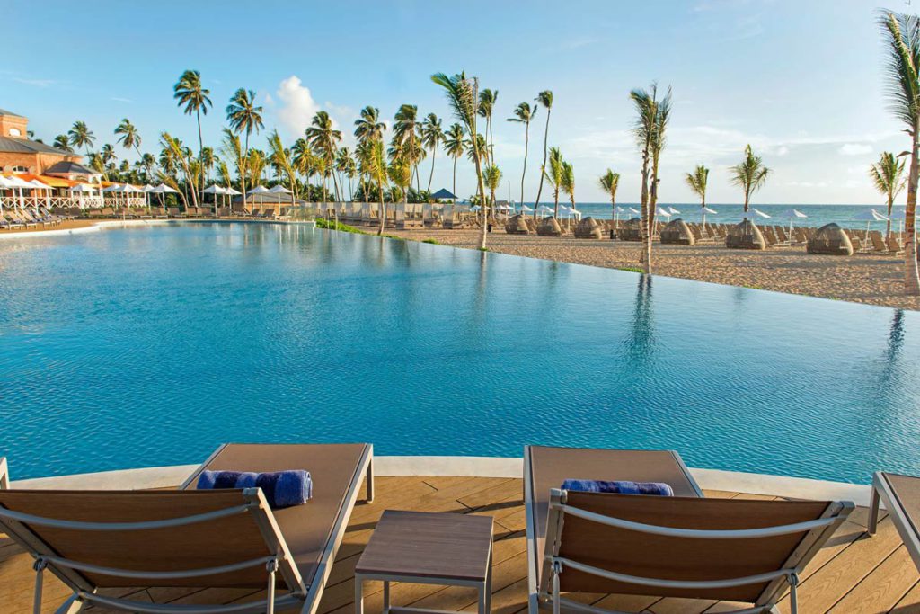 Two lounge chairs placed in front of the pool at the Nickelodeon Resort Punta Cana