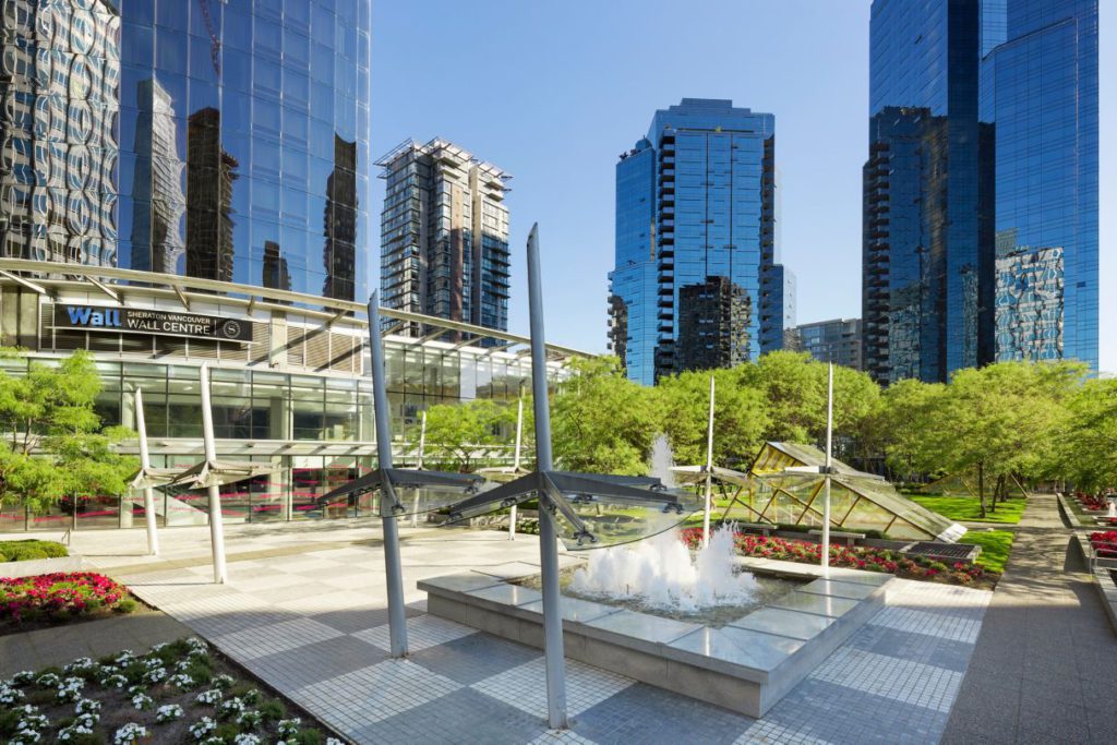 An exterior view of the Sheraton Vancouver Wall Centre surrounded by fountains.