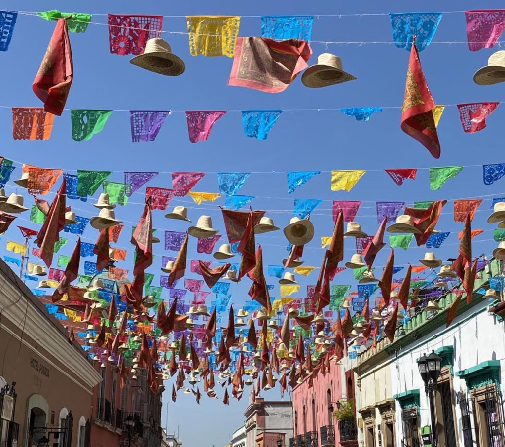Sombreros and handkerchiefs hanging from the Old Town in Oaxaca, Mexico.