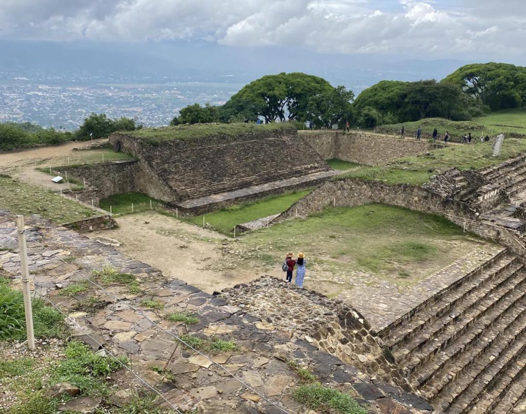 Two people overlooking the ruins at Monte Alban during their Oaxaca itinerary for families.