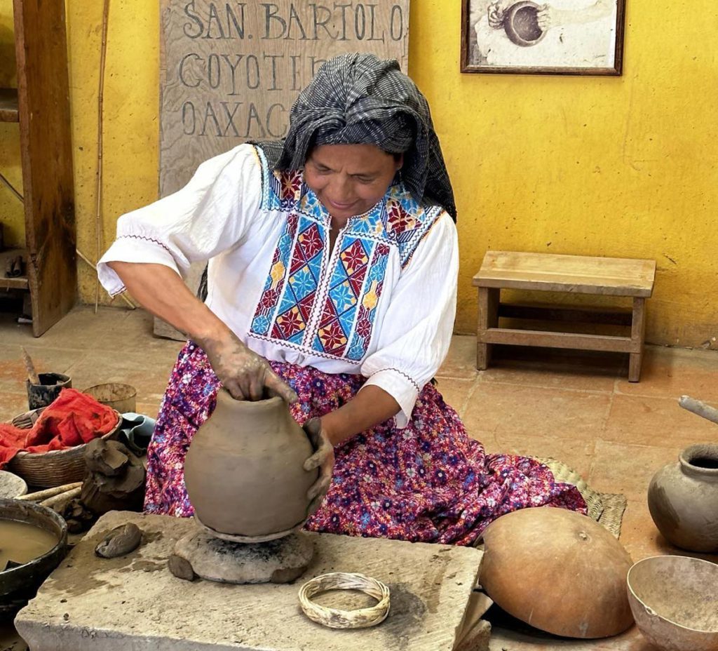 An artisan making black pottery in Santa María Atzompa, one of the best plaes to visit on a Oaxaca itinerary for families. 