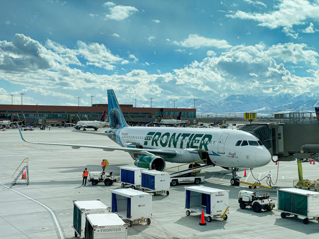 A frontier airlines plane on the runway. Frontier Airlines also has specific airlines policies for kids!