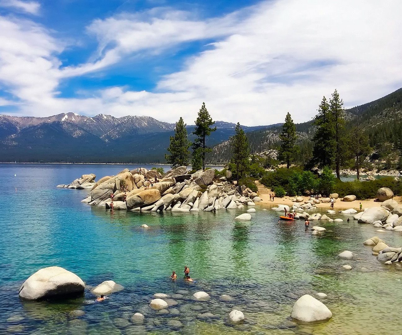 Kids playing in the turquoise blue water of Lake Tahoe.