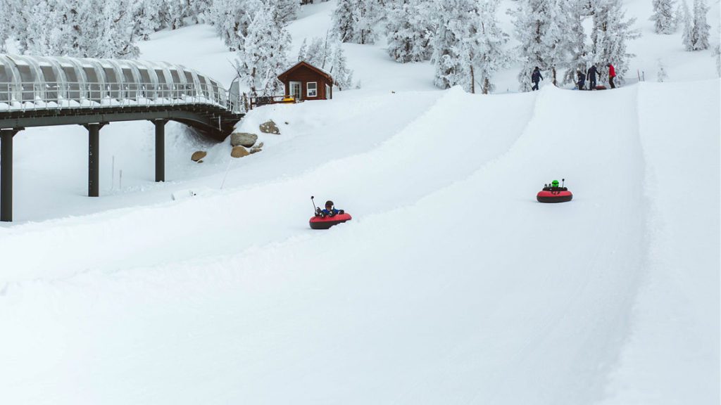 Two kids snow tubing at Heavenly Resort in South Lake Tahoe. 