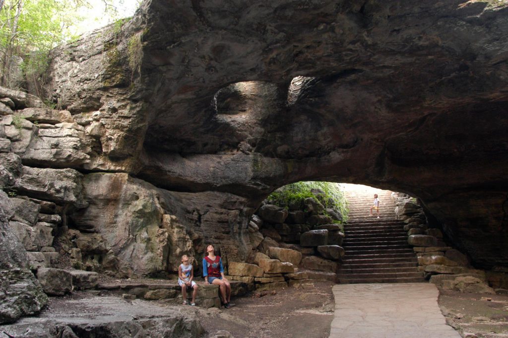 A parent and child in Longhorn Cavern State Park, one of the best places to visit in Texas with kids. 