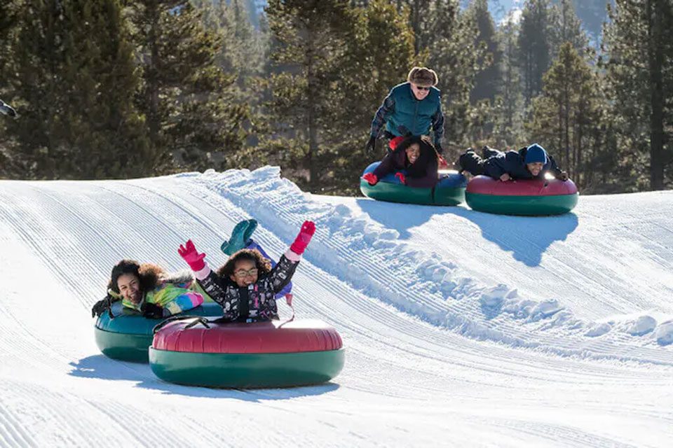 A family snow tubing at Tahoe Snowmobiles and Tubing.