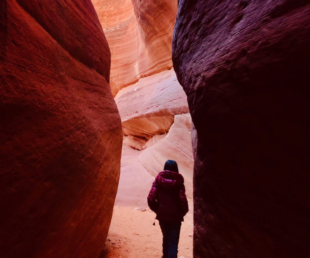 A young girl in a slot canyon near Kanab, Utah, one of the best weekend getaways from Las Vegas for families! 