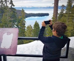 A child taking a photo in Lake Tahoe, California.
