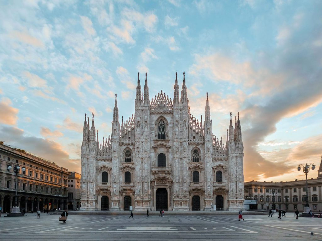 The Duomo in Milan surrounded by a beautiful sunset. This is one of the best things to do on an Italy itinerary with kids. 
