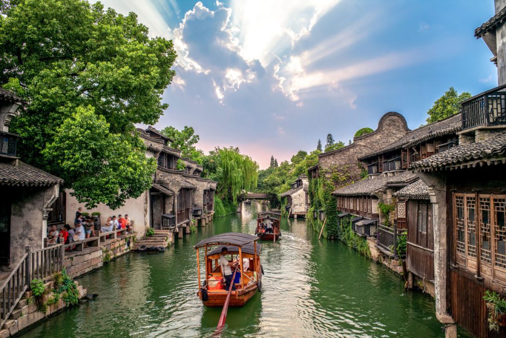 A boat going down the water in Wuzhen, one of the best places to visit in China with kids. 