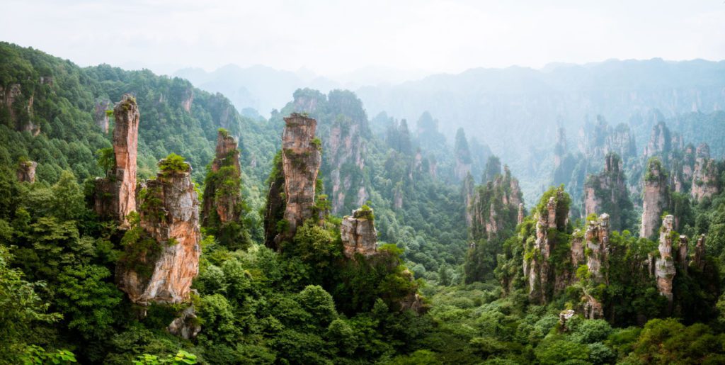 Towering spires rising from the greenery in the Zhangjiajie National Forest, one of the best places to visit in China with kids.
