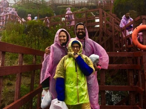 Niagara Vacation Families, Family on the stairs in front of Niagara Falls wearing rain coats