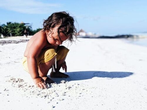 Cancun Vacation Kids, Little boy on beach playing in the sand in Cancun Vacation Families